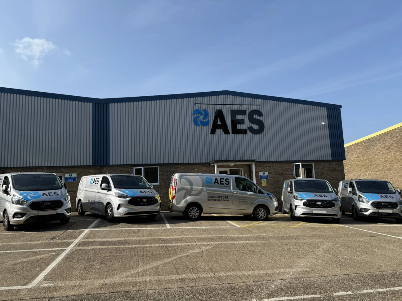 AES Warehouse with fleet of servicing vehicles outside